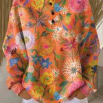 Britt - Trui in oranje met bloemen